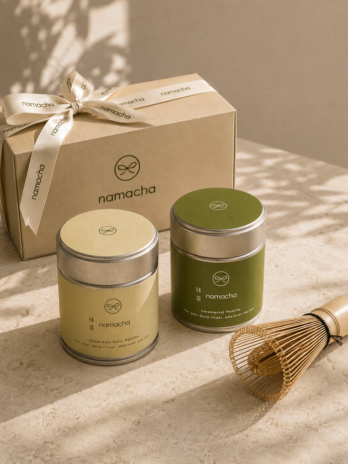 Namacha matcha cadeau met Okumidori en Ceremonial tin naast een chasen op een lichte ondergrond.